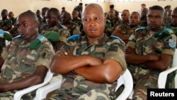 FILE - Congolese soldiers follow proceedings during the mass trial of 39 soldiers inside a military court in Goma in eastern Democratic Republic of Congo, May 5, 2014. 