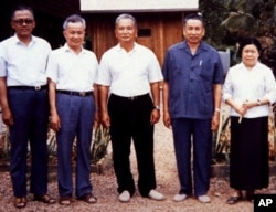 FILE - Pol Pot (2nd R), notorious leader of Cambodia's Khmer Rouge, is shown in a rare photograph with other Khmer Rouge leaders at a camp in Western Cambodia in January, 1986.