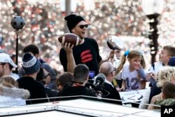 New England Patriots' Tom Brady rides a duck boat during the Patriots parade through downtown Boston, Feb. 5, 2019, to celebrate their win over the Los Angeles Rams in Sunday's NFL Super Bowl 53.
