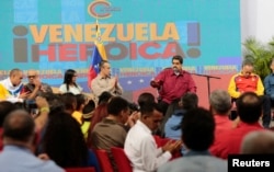 FILE - Venezuela's President Nicolas Maduro, 2nd right, speaks during a meeting with members of the Constituent Assembly in Caracas, Venezuela, Aug. 2, 2017. The text in the back reads, "Heroic Venezuela."