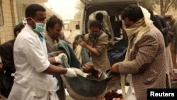 People carry the body of a man killed in an air strike on a market place in Yemen's northwestern province of Saada March 27, 2015. Warplanes targeted Houthi forces controlling Yemen's capital and their northern heartland on Friday, the second day of a Sau