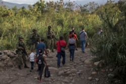 Venezuelans cross illegally back to their country after buying food in La Parada near Cucuta, Colombia, Oct. 5, 2021.
