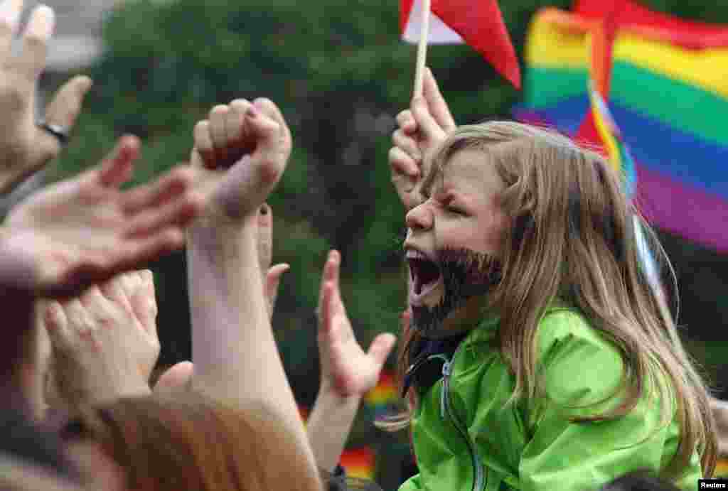 A child cheers during a concert by Eurovision Song Contest winner Conchita Wurst of Austria in Vienna.