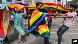Members of the LGBT community dance to celebrate after the country's top court struck down a colonial-era law that made homosexual acts punishable by up to 10 years in prison, in Bangalore, India, Sept. 6, 2018. 
