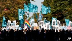 Demonstrators march through Washington toward the U.S. Capitol to rally and demand that the U.S. Congress investigate the National Security Agency's mass surveillance programs, Oct. 26, 2013.