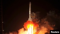 The Long March-3B rocket carrying the Chang'e-3 lunar probe blasts off from the launch pad at Xichang Satellite Launch Center, Sichuan province, in the early morning hours, Dec. 2, 2013. 