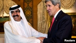 U.S. Secretary of State John Kerry (R) is greeted by Qatari Emir Hamad bin Khalifa Al Thani at Wajbah Palace in Doha, June 23, 2013.