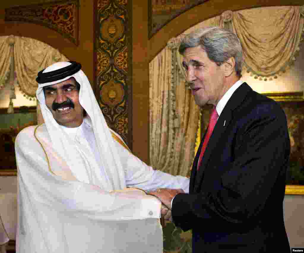 U.S. Secretary of State John Kerry is greeted by Qatari Emir Hamad bin Khalifa Al Thani at Wajbah Palace in Doha, June 23, 2013.