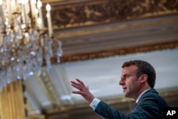 French President Emmanuel Macron addresses Paris Firefighters' brigade and security forces who took part at the fire extinguishing operations of the Notre Dame of Paris Cathedral fire, at the Elysee Palace in Paris, April 18, 2019.