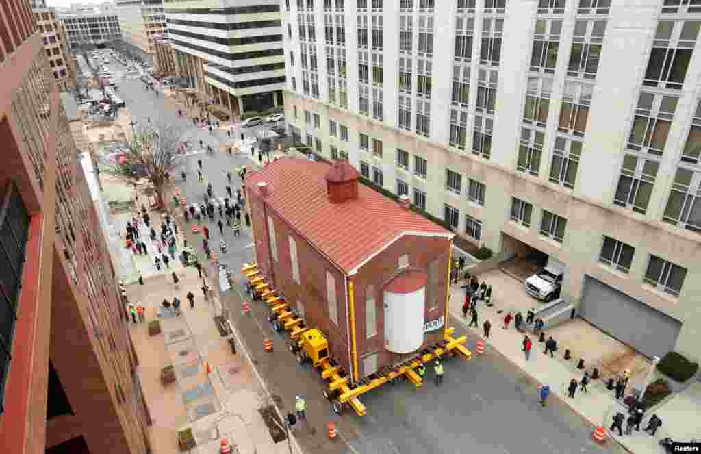 Washington&#39;s first and oldest synagogue, Adas Israel Synagogue, is moved on a remote controlled platform to its new location where it will become be the cornerstone of the Capital Jewish Museum on 3rd St. NW in Washington, D.C.