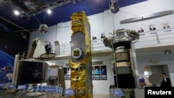The Express-1000, from left, Glonas-K and Ekran-AM satellites are on display at the Educational and Demonstration center of the Siberian State Aerospace University to mark Cosmonautics Day on April 12, 2017, in the Siberian city of Krasnoyarsk, Russia.