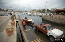 Mexico Tropical Weather Newton: Residents tow a boat out of the water as they prepare for the arrival of Hurricane Newton in Cabo San Lucas, Mexico, Monday Sept. 5, 2016.