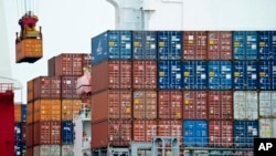 FILE - A container is loaded onto a cargo ship at the Tianjin port in China, Aug. 5, 2010. With the apparent death of the Trans-Pacific Partnership, China sees a chance at forming its own Pacific free trade area. 