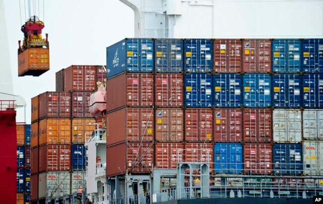 FILE- A container is loaded onto a cargo ship at the Tianjin port in China, Aug. 5, 2010.