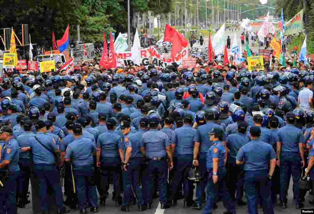 پلیس ضد شورش جلوی معترضانی که مقابل سفارت آمریکا در فیلیپین جمع شدند را می&zwnj; گیرد. این معترضان خواستار حذف حضور نظامی آمریکا هستند؛ سیاستی که مدنظر رودریگو دوترته، رئیس جمهوری این کشور است.