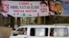 An Egyptian drives past banners supporting presidential candidate Abdel-Fattah el-Sissi in Cairo, Egypt, May 27, 2014. 