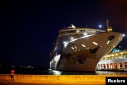 A man uses his mobile phone near the cruise ship Norwegian Sky in Havana, Cuba, May 9, 2017.