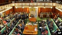 FILE - Uganda's Prime Minister, standing center-left, addresses Members of Parliament in Kampala, Uganda, Sept. 21, 2017.