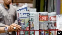一名男子在马来西亚沙阿兰的一家杂货店拿一份报纸。（资料照片，2018年3月26日）