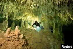 A scuba diver measures the length of Sac Aktun underwater cave system as part of the Gran Acuifero Maya Project near Tulum, in Quintana Roo state, Mexico, Jan. 24, 2014.