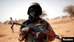 FILE - A Malian soldier patrols in Mali, Oct. 20, 2017.