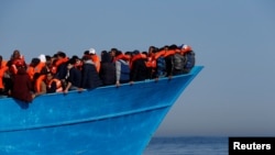 Migrants attendant d'être secourus par l'ONG Migrant Offshore Aid Station au large des côtes de Sabratha en Libye, le 15 avril 2017.