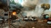 FILE - In this photo provided by the Karenni Nationalities Defense Force (KNDF), smokes and flames billow from vehicles in Hpruso township, Kayah state, Myanmar, Dec. 24, 2021.