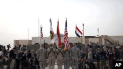 The US flag, Iraq flag, and the US Forces Iraq colors are seen before they are carried in during ceremonies marking the end of US military mission, December 15, 2011 in Baghdad, Iraq.