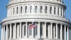 USA, Washington, The American Flag flies at the U.S. Capitol Building