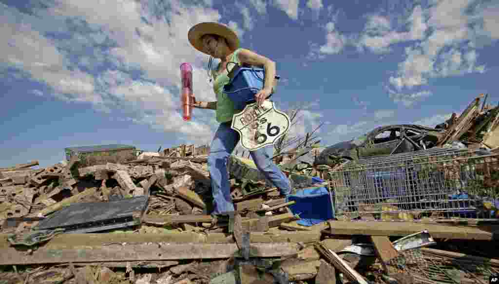 Susan Kates salvages items from a friend's tornado-ravaged home, May 22, 2013, in Moore, Oklahoma.