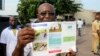 A health worker displays an Ebola information leaflet for passengers at Ngobila Beach in Kinshasa, Democratic Republic of Congo, May 24, 2018. 