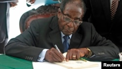 Zimbabwe President Robert Mugabe signs Zimbabwe's new constitution into law, Harare, May 22, 2013.