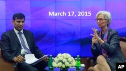 Managing Director of the International Monetary Fund Christine Lagarde, right, speaks as Governor of Reserve Bank of India (RBI) Raghuram Rajan looks on during an event at the RBI headquarters in Mumbai, India, March 17, 2015. 