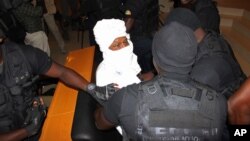 Security personnel surround former Chadian dictator Hissene Habre inside the court, in Dakar, Senegal, July 20, 2015.