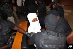 Security personnel surround former Chadian dictator Hissene Habre inside the court, in Dakar, Senegal, July 20, 2015.