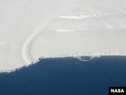 Calving front of an ice shelf in West Antarctica taken on a NASA mission focused on gatering data for the new ice shelf study.