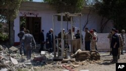 Egyptian security officials investigate checkpoint attacked by gunmen in Shubra al-Kheima, a suburb north of Cairo, March 15, 2014.