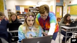 FILE — Teacher Carol Mowen, right, works with student Kirsten Delauney on an oral history project at Washington County Technical High School in Hagerstown, Md. 