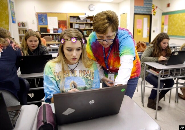 FILE — Teacher Carol Mowen, right, works with student Kirsten Delauney on an oral history project at Washington County Technical High School in Hagerstown, Md.