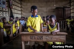 FILE - Children in Ghana use their e-readers in class to access Worldreader's digital library. Ghana introduced free compulsory education at the primary and junior high school levels in 1995. (Worldreader)