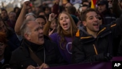 People shout slogans during a Podemos party march in Madrid, Jan. 31, 2015.