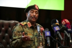 Sudan's head of the military, Gen. Abdel-Fattah Burhan, speaks during a press conference at the General Command of the Armed Forces in Khartoum, Oct. 26, 2021.