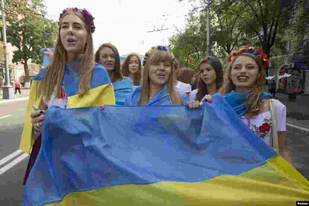 Ukrainian school girls take part in a rally against war in the southern coastal town of Mariupol.