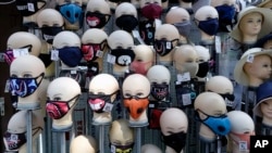 Masks placed on mannequins heads are displayed outside a shop in Sarajevo's main street, Bosnia, Monday, July 27, 2020. 