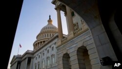 The sun begins to set against the Capitol dome as the budget battle continues, Sept. 30, 2013 in Washington. 