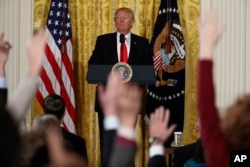 FILE - President Donald Trump looks at reporters during a news conference in the East Room of the White House in Washington, Feb. 16, 2017.