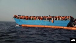 Migrants are crowded on to the vessel in the Mediterranean Sea off the coast of Libya in this Oct. 4, 2016 image taken from video. 