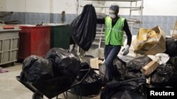 Workers from an environmentally-friendly rubbish disposal business called ScrapApp sort through garbage in a shopping mall in Noida, India, Aug. 11, 2016. 