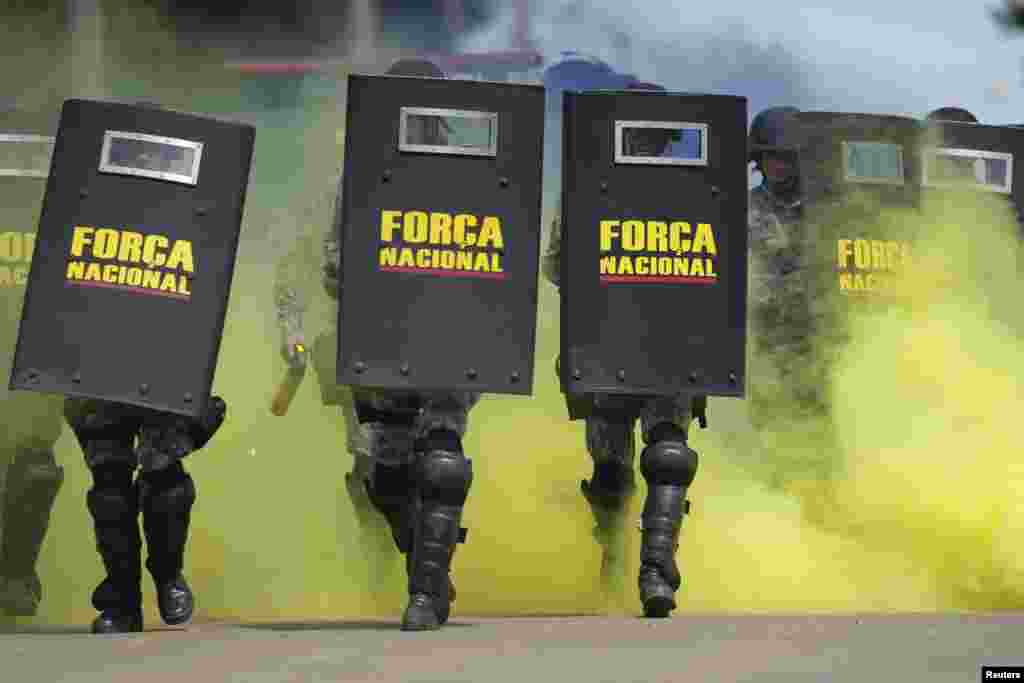 Members of the National Security Force practice crowd control during training to provide security at the 2014 World Cup, in Brasilia, Brazil. The World Cup will be held in 12 cities in Brazil in June.