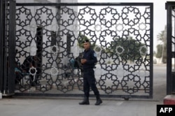FILE - A member of the Palestinian security forces stands guard at the Rafah border crossing with Egypt in the southern Gaza Strip, Sept. 26, 2018.
